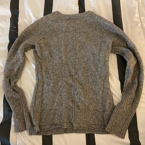 Selling a grey sweater that looks like it’s inside out, but that’s the style.
